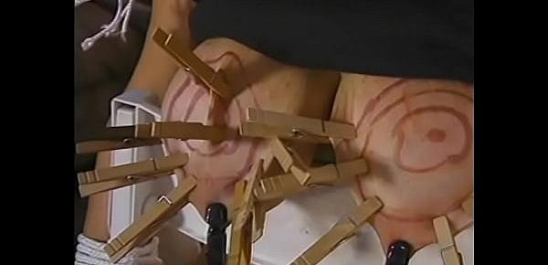  Two mature dudes bring a busty whore into the living room and hang clothespins on her intimate places